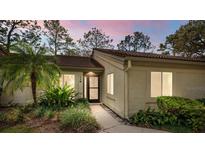 Inviting one-story home featuring a lush landscaped front yard and a cozy, welcoming entrance at 178 W Sabal Palm Pl # 62, Longwood, FL 32779