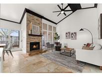 Bright living room with vaulted ceilings, stone fireplace, and lots of natural light at 178 W Sabal Palm Pl # 178, Longwood, FL 32779