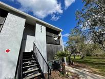 Charming two-story condo with a private balcony, surrounded by lush greenery and a well-manicured lawn at 4882 S Semoran Blvd # 1408, Orlando, FL 32822