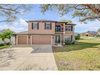 Charming two-story home featuring a three-car garage and a welcoming front yard with mature trees at 524 Quail View Ct, Debary, FL 32713