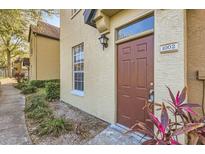 Charming townhome featuring a well-maintained front yard and a warm, inviting entrance at 6340 Raleigh St # 1002, Orlando, FL 32835
