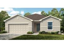 Charming single-story home with a two-car garage, lush lawn, and attractive neutral-toned facade at 7392 Capstone Dr, Groveland, FL 34736