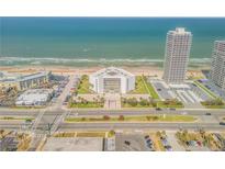 Aerial shot of beachside building with palm trees and landscaping at 901 S Atlantic Ave # 208, Ormond Beach, FL 32176