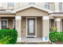 Inviting front entryway with a secure, modern door and well-maintained landscaping at 10566 Green Ivy Ln, Orlando, FL 32832