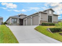 Beautiful craftsman-style home featuring a well-manicured lawn and a spacious three-car garage at 1094 Red Maple Way, New Smyrna Beach, FL 32168