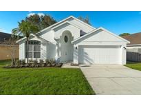 Charming single-story home featuring a well-manicured lawn, attached garage, and an attractive white facade at 2902 Egrets Landing Dr, Lake Mary, FL 32746