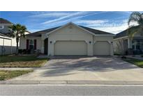 Charming single-story home featuring a three-car garage, well-manicured lawn, and a beautifully paved driveway at 3942 Green Sabal Dr, Orlando, FL 32824