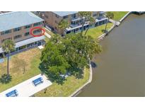 Aerial view of waterfront condo with lush landscaping and community dock at 415 N Halifax Ave # 216, Daytona Beach, FL 32118