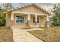 Inviting single-story home featuring a charming front porch with brick accents and a well-defined walkway at 532 W Park St, Lakeland, FL 33803