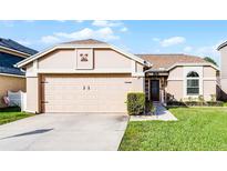 Charming single-story home with a well-maintained lawn, a two-car garage, and neutral exterior paint at 1006 Gotwalt Dr, Oviedo, FL 32765