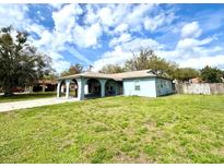 Charming single-story home featuring an inviting covered entry and a well-maintained lawn under a sunny sky at 1207 Rich Moor Cir, Orlando, FL 32807