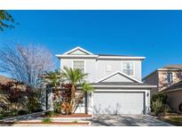 Charming two-story home featuring a well-manicured lawn and an attached two-car garage at 14415 Estrella Dr, Orlando, FL 32837