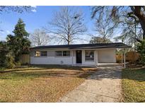 Charming single-story home with a covered parking and a well-maintained front yard at 17 Fanfair Ave, Orlando, FL 32811