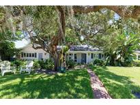 Charming home with lush front yard, mature trees, and inviting entrance with beautiful landscaping at 1721 Cheyenne Trl, Maitland, FL 32751