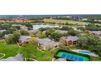 Gorgeous aerial view of community showcasing lush landscaping, pool, and nearby lake at 184 Villa Di Este Ter # 200, Lake Mary, FL 32746