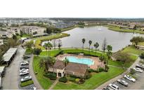 Beautiful community view of a clubhouse, swimming pool, lake, and condos at 3301 Whitestone Cir # 204, Kissimmee, FL 34741