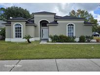 Beautiful single-story home with lush green lawn and lovely landscaping at 4151 Forest Island Dr, Orlando, FL 32826