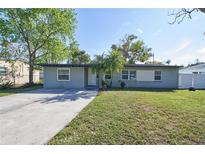 Charming one-story home with well-maintained lawn, driveway and mature trees at 5454 San Juan Blvd, Orlando, FL 32807