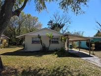 Cozy single-story home with a carport and mature landscaping in a quiet neighborhood at 1130 E Bay St, Winter Garden, FL 34787