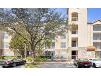 Beautiful exterior shot of a four-story building showing balconies and manicured landscaping at 1371 Tuscan Terrace # 3203, Davenport, FL 33896