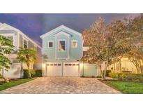 Charming two-story home with a brick driveway and two-car garage at 1427 Fairview Cir, Reunion, FL 34747