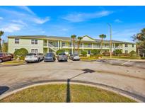 Inviting condo complex with ample parking, lush landscaping, and light green exterior at 3162 Sun Lake Ct # B, Kissimmee, FL 34747