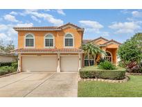 Charming two-story home with a well-manicured lawn and a convenient two-car garage at 2326 Wintermere Pointe Dr, Winter Garden, FL 34787