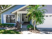 Charming home featuring a welcoming front entrance with a well-manicured garden and a lovely white door at 418 S Summerlin Ave, Sanford, FL 32771