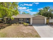 Charming single-story home with stone accents, manicured lawn, and inviting curb appeal under a bright blue sky at 655 E Lake View Rd, Lake Alfred, FL 33850