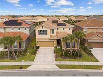 Stunning two-story home boasts well-manicured landscaping, tile roof, and solar panels for energy efficiency at 7630 Oakmoss Loop, Davenport, FL 33837