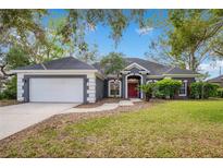 Charming single-Gathering home featuring a well-manicured lawn and a classic color scheme at 827 Royalwood Ln, Oviedo, FL 32765