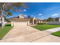 Charming one-story home with a two car garage, well-manicured lawn, and welcoming entryway at 2901 Eagle Lake Dr, Orlando, FL 32837