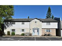 Charming two-story condo with light blue shutters and well-maintained landscaping in a well-lit parking area at 3057 Aaron Burr Ave # 1, Winter Park, FL 32792