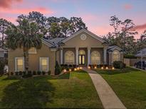 Stunning home featuring a well-manicured lawn, elegant architecture, and inviting walkway at 358 Woldunn Cir, Lake Mary, FL 32746