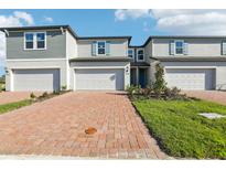 Charming townhome with brick driveway, attached garage, manicured lawn, and delightful curb appeal at 4369 Switchgrass Ln, St Cloud, FL 34772