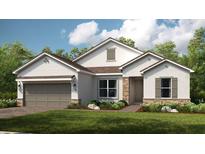 Charming single-story home with stone accents, a two-car garage, and a well-manicured front lawn at 5647 Nevis Ter, Kissimmee, FL 34758