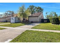Charming single-story home with a well-manicured lawn and sunny sky at 626 Golden Sunshine Cir, Orlando, FL 32807