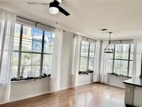 Bright living room with hardwood floors, a ceiling fan, and lots of natural light at 860 N Orange Ave # 318, Orlando, FL 32801