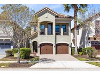 Inviting two-story home boasts a charming balcony and a two-car garage for convenient parking at 1004 Castle Pines Ct, Reunion, FL 34747