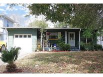 Charming single-story home with a well-manicured lawn and attached garage at 115 W King St, Orlando, FL 32804