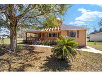 Charming single-Gathering home featuring a covered porch, mature tree, and well-maintained landscaping in a quiet neighborhood at 154 Pecan Dr, Ocala, FL 34472