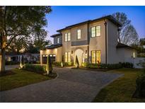 Stunning two-story home with modern design, manicured landscaping, and a welcoming circular driveway at 1833 Loch Berry Rd, Winter Park, FL 32789