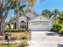 Charming single-story home with a well-manicured lawn, mature trees and attached two car garage at 2112 White Eagle St, Clermont, FL 34714