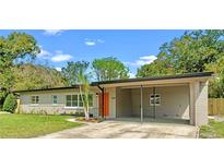 Charming single-story home featuring a covered carport and manicured lawn at 3518 Shirley Dr, Apopka, FL 32703
