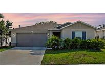 Charming single-Gathering home featuring a well-maintained lawn and an attached two-car garage at 4475 Casablanca Ave, Kissimmee, FL 34746