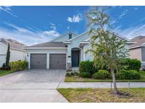 Charming single-story home featuring a two-car garage, manicured landscaping, and a welcoming entryway at 706 Hyperion Dr, Debary, FL 32713