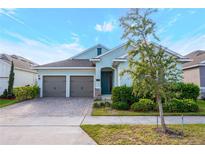 Charming one-story home featuring a two-car garage, beautiful landscaping, and a welcoming entrance at 706 Hyperion Dr, Debary, FL 32713