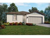 Charming single-story home featuring a two-car garage, stucco exterior, and beautifully landscaped front yard at 2094 Rosewood Dr, Bartow, FL 33830