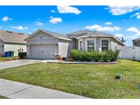 Charming single-story home featuring a well-maintained lawn and lovely curb appeal with neutral tones at 3086 Brenton Manor Loop, Winter Haven, FL 33881