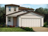 Two-story home with brown accents, light colored siding, two-car garage, and front yard landscaping at 3213 Viceroy Ct, Poinciana, FL 34759